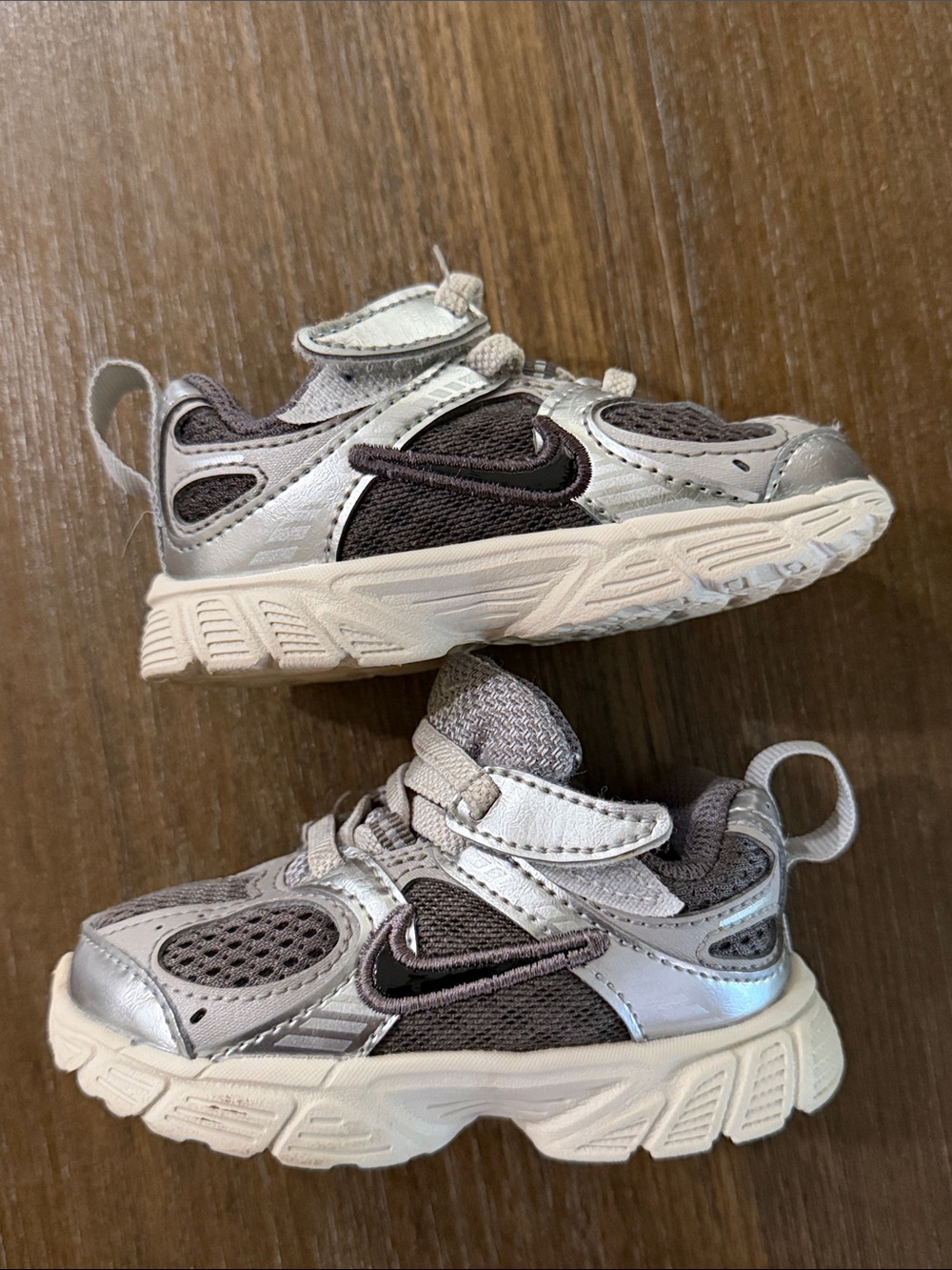 Nike Kids Silver and Dark Gray Athletic Sneakers with Black Swoosh